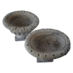 Unmatched pair of carved marble urns