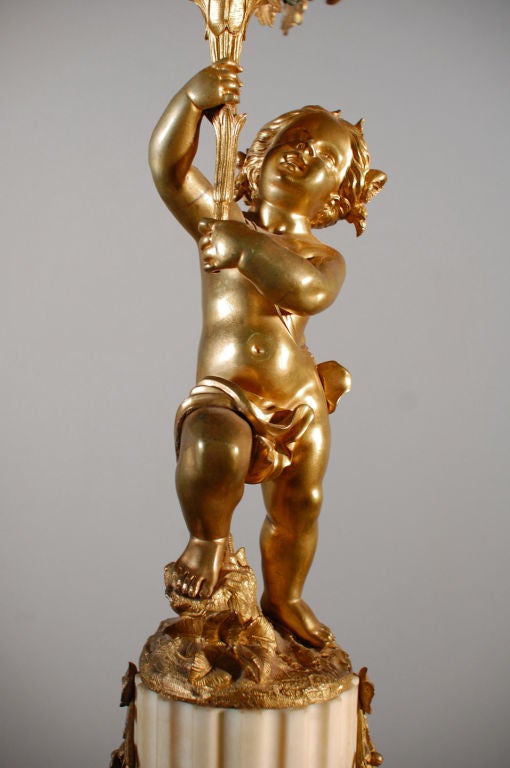 Pair of Cherub Candelabras Holding Flower Bouquet