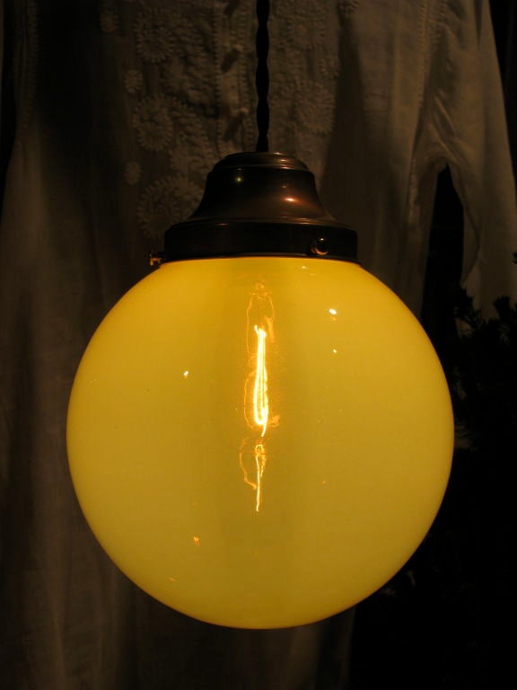 Beautiful Vaseline Glass Globe<br />
Newly rewired with antique brass fitter and black braided cloth cord. <br />
Custom drop height, edison bulb