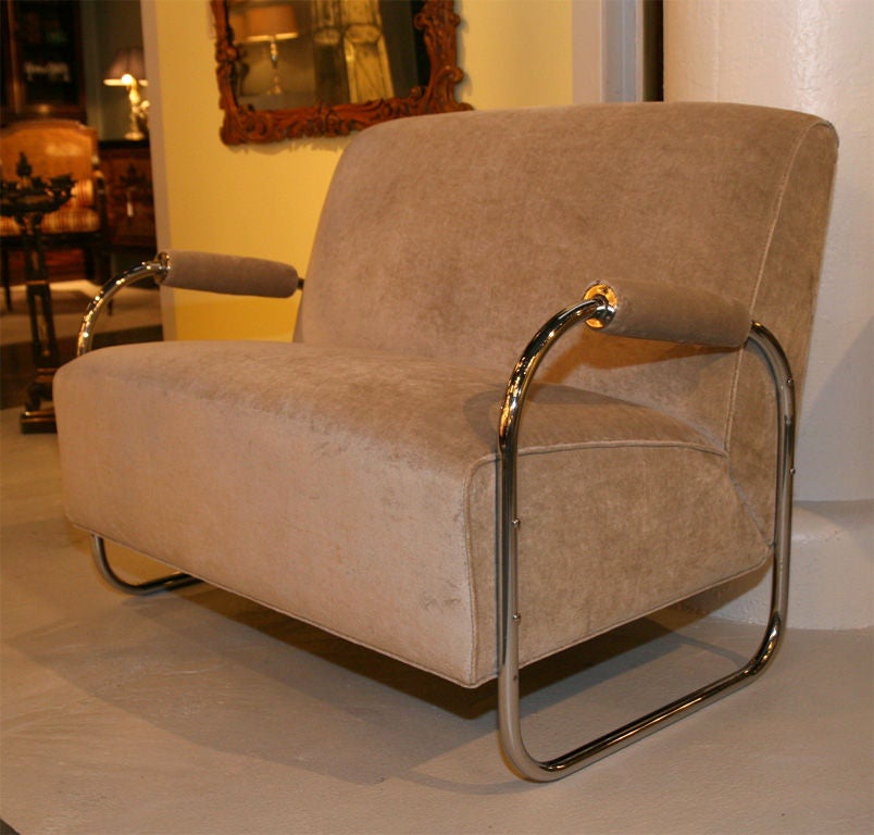 Exceptional Gilbert Rohde tubular chrome Art Deco settee, this modernist two-seat sofa is a rare design loveseat, newly upholstered in a light sand colored mohair velvet. Please also visit sjulian.1stdibs. to see more of our collection.