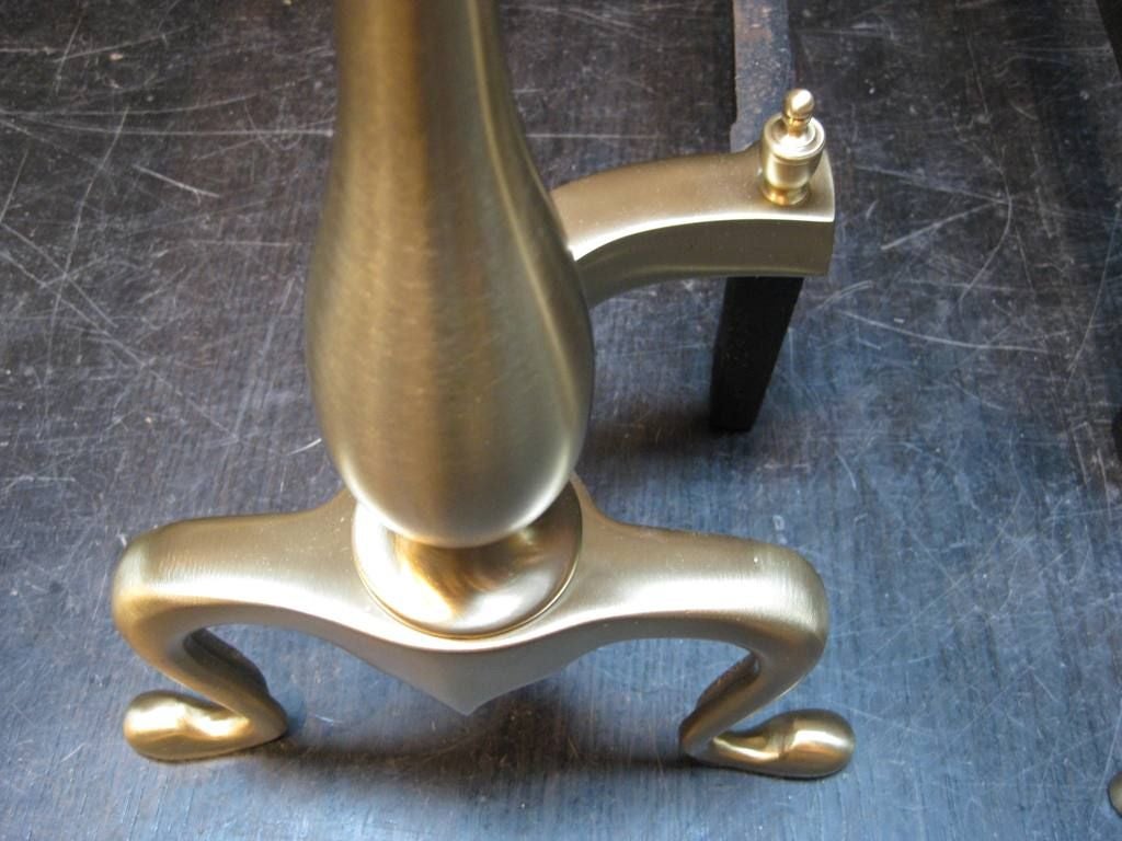 Pair of Traditional Andirons in satin brass, these are a Time Honoured Elegant design, lasting from Art Deco Through Mid-Century Modern to present, also available a large selection In nickel and one pair in Regency polished brass, we provide rentals