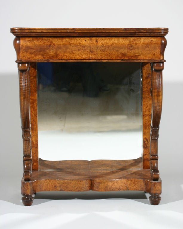 A French early 19th century burl elm Charles X period mirror back console.