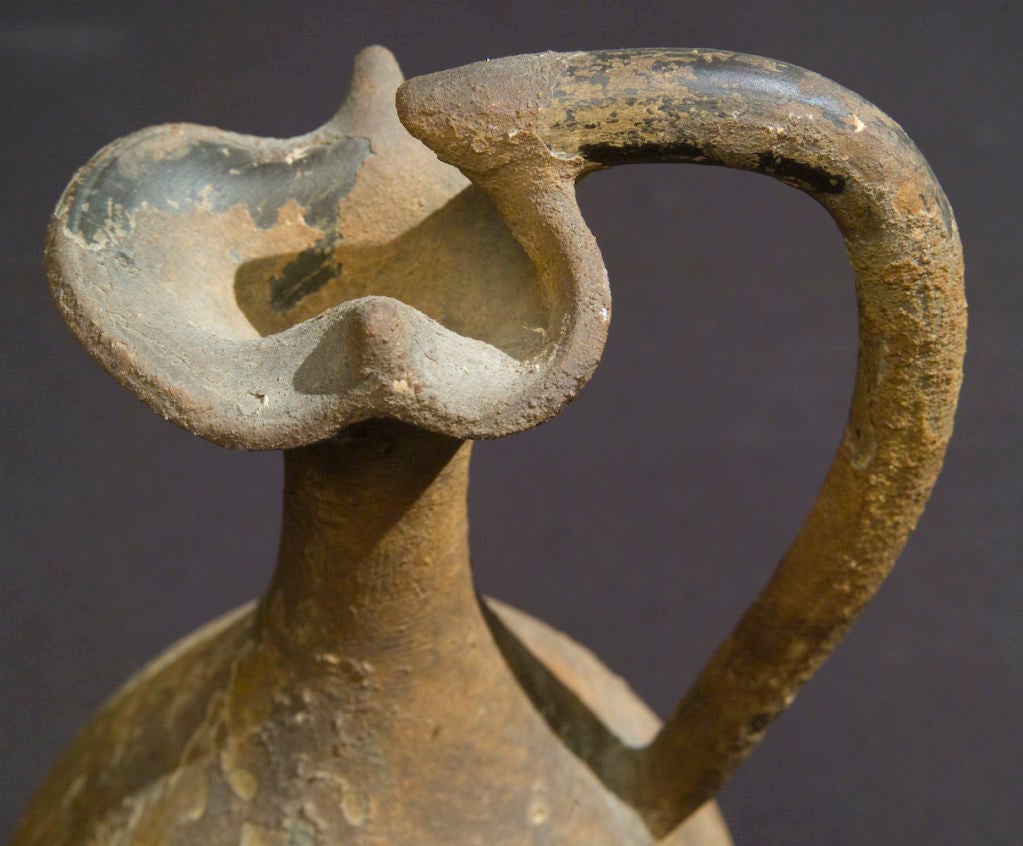 A heavily encrusted Greek black-glazed oinochoe (wine pitcher), probably from a greek colony in southern Italy.