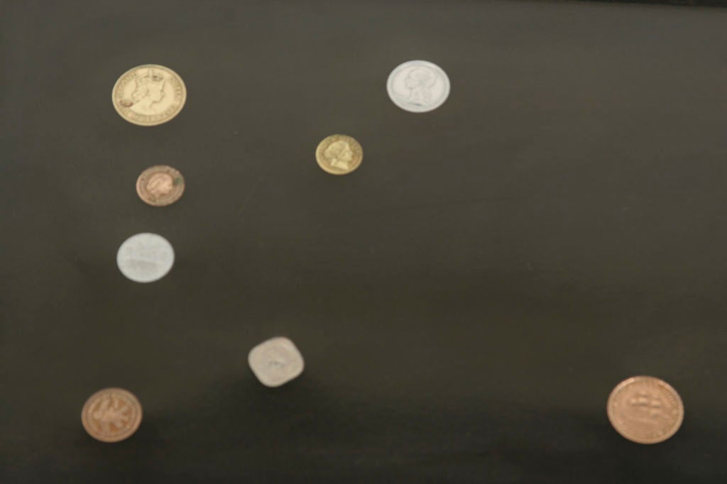 Mid-Century rectangular bakelite tray inlaid with foreign coins by Couroc of Monterrey, California.