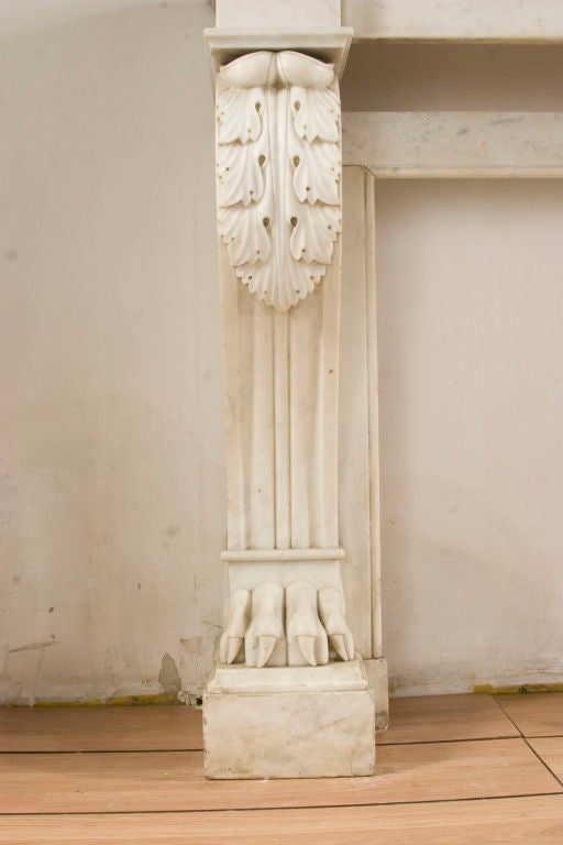Restauration period white carrara marble fireplace mantel - finely carved with neoclassical attributes.

Interior dimensions:
H:27.5 W:37.5 in.