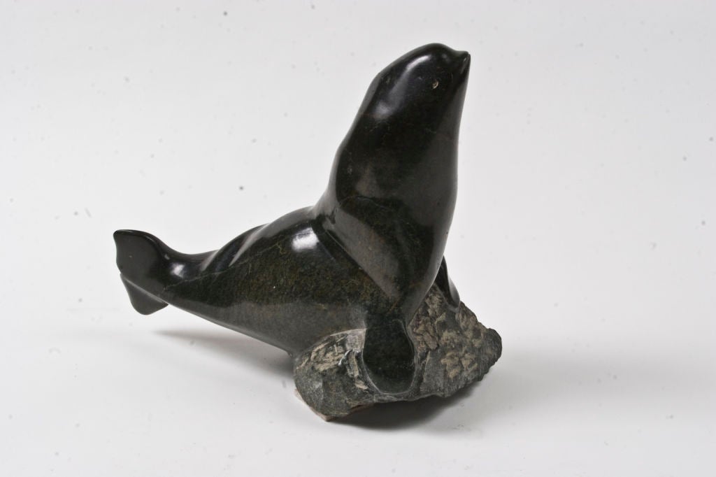 Green soapstone Inuit carving of a whale by Nuzaliaq Qimirpik.