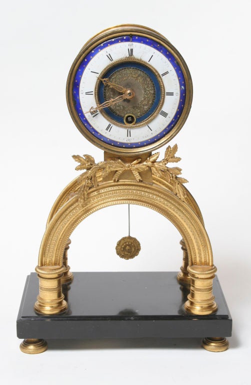 Rare Louis XVI period enamel and gilt bronze clock on a black marble base.