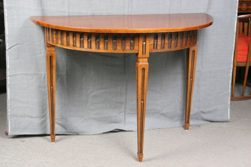 Beautiful pair of solid olivewood neoclassical style demilune console tables. Both ends can also be joined to form a circular table. A later extension was made to fit between both ends to form an oval dining table.