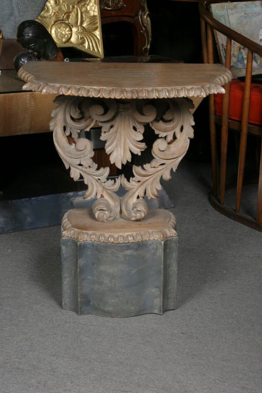 Diminutive pair of Baroque style carved and painted limed wood consoles.