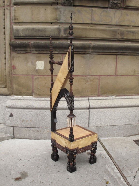 Ebonised walnut high back mosque chair by Carlo Bugatti (1856-1940) decorated with pewter and bone inlay and embossed copper, upholstered with parchment.<br />
<br />
Rare and important suite of five pieces of furniture by Carlo Bugatti comprising