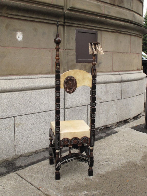 Ebonised walnut mosque chair by Carlo Bugatti (part of a suite of six pieces) decorated with pewter and bone inlay and embossed copper, upholstered with parchment, the back painted with birds on a branch.<br />
<br />
Rare and important suite of