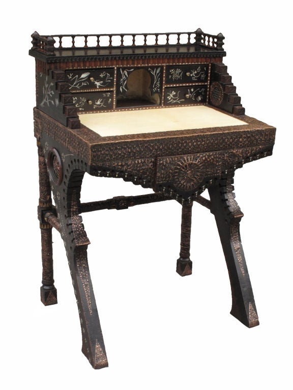Ensemble of ebonised walnut writing desk and chair (part of a suite of five pieces) by Carlo Bugatti (1856-1940), both upholstered with parchment and decorated with bone and pewter inlay and embossed copper.<br />
<br />
Rare and important suite