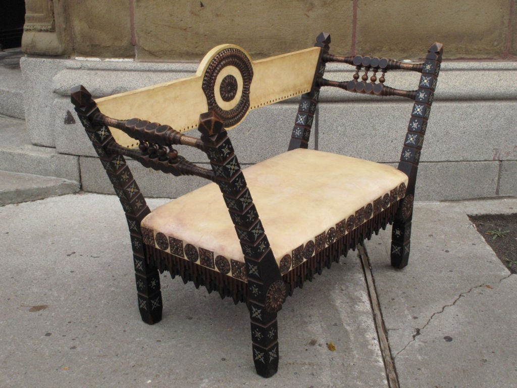 Rare and important suite of five pieces of furniture by Carlo Bugatti (1856-1940) comprising a writing desk, a center table, a settee and two chairs all in walnut and ebonised wood, inlaid with pewter, copper, brass and bone, fitted with hammered