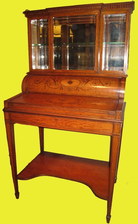 This exquisite desk, made by the celebrated partnership, is of the highest quality. The glazed upper section is perfect for the display of objet d'art, the cylinder top which is opened by pulling on the frieze drawer reveals a fitted interior and