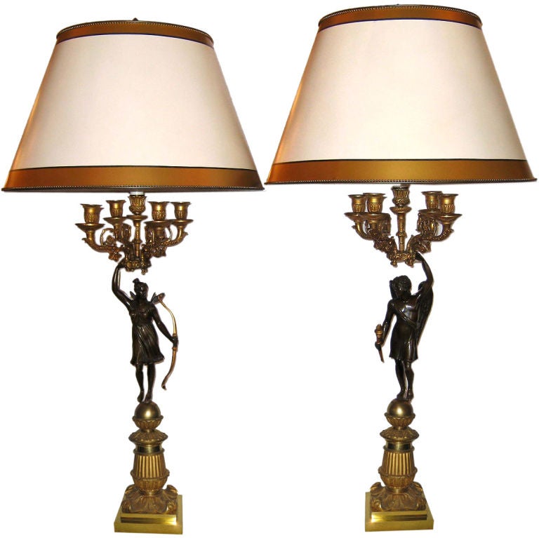 A pair of early 19th century French gilt bronze and patinated bronze figural empire period five lights candelabra. Each candelabrum is formed as a ormolu cornucopia of scrolled branches enriched with very fine hand chiseled leaf motifs and rosettes