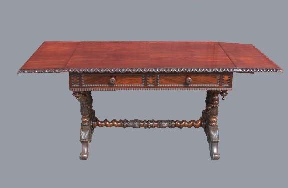 Napoleon III  strongly figured sofa table of typical form, but.edged with egg and dart molding. The two drawers are lined in bird's-eye maple, raised on twin column supports with foliate decoration and scrolled feet united  by an acanthus and barley