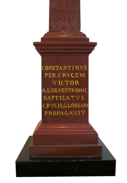 A magnificent grand tour rouge marble obelisk of Cleopatra’s Needle, on a stepped square base terminating in a black marble square base, with an elaborate inscription:  CONSTANTINVS PER.CRVCEM VICTOR A.S. SILVESTROHIC BAPTIZATVS CRVCIS. GLORIAM