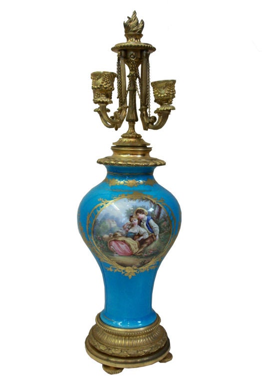 Stunning pair porcelain Sevres-style and ormolu signed Henri Picard, four light candelabra. The Celeste blue porcelain ovoid bodies hand painted with romantic scenes on one side and florals on reverse side. Topped with a flame finial and four candle