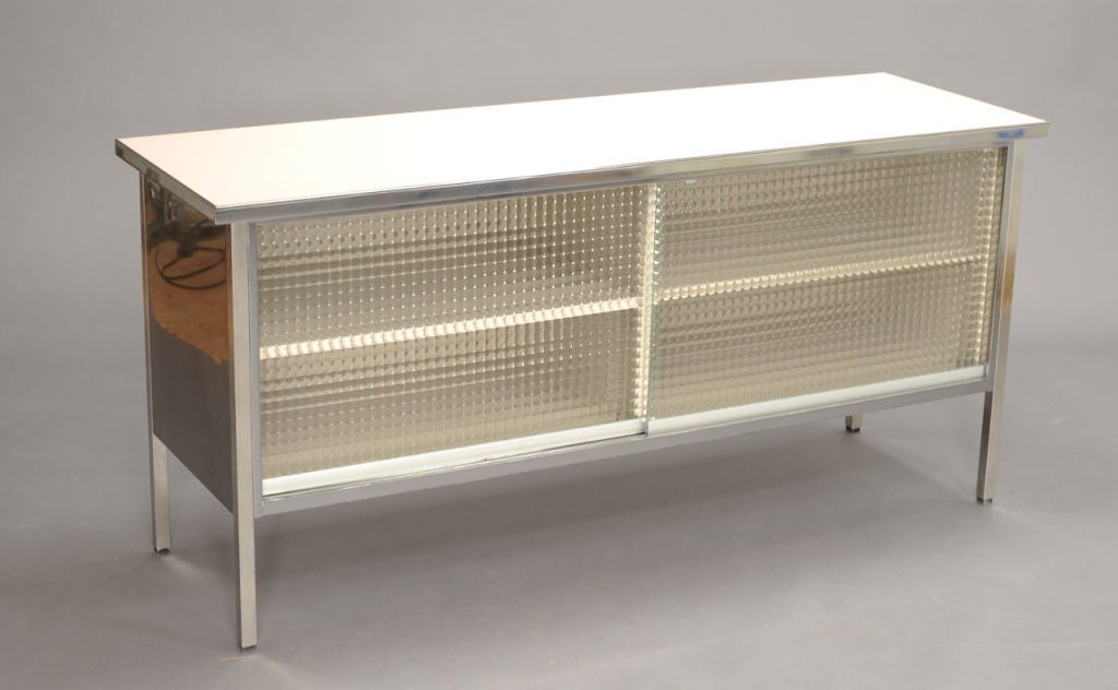 Midcentury steel credenza by Steelcase.  This cabinet features obscured glass sliding doors and polished steel body. Formica tops come in a large variety of colors.  Multi purpose cabinet excellent for use as bookcase, display, office storage, 