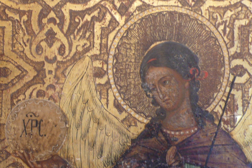 A Moscow School Icon depicting three figures of Saints painted in vibrant colors on a gold gilded background.