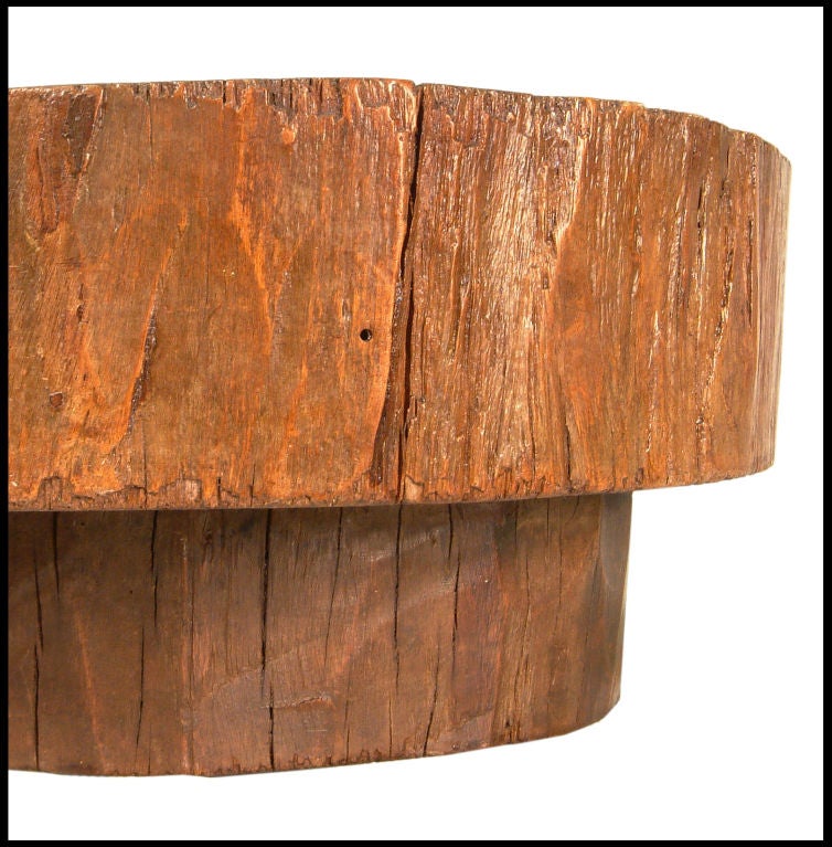 Small solid tree trunk table made of a thick cross section of wood. Designed by Joaquim Tenreiro, Brazil, 1955.