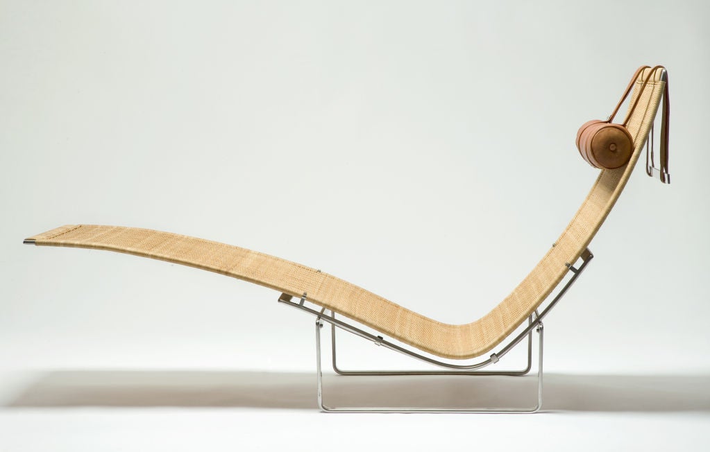 PK 24 chaise longue with frame of stainless steel, seat and back in cane, headrest in light brown leather. Designed by Poul Kjaerholm Produced for E. Kold Christensen, Denmark, 1965.
