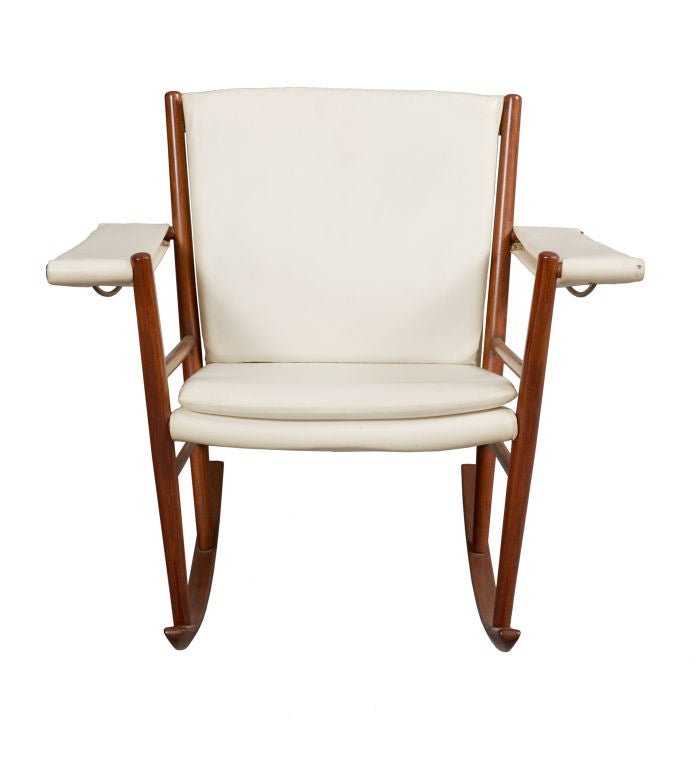 Rocking chair with frame in jacaranda and white leather seat and arm rests.  Designed by Joaquim Tenreiro, Brazil, 1947.