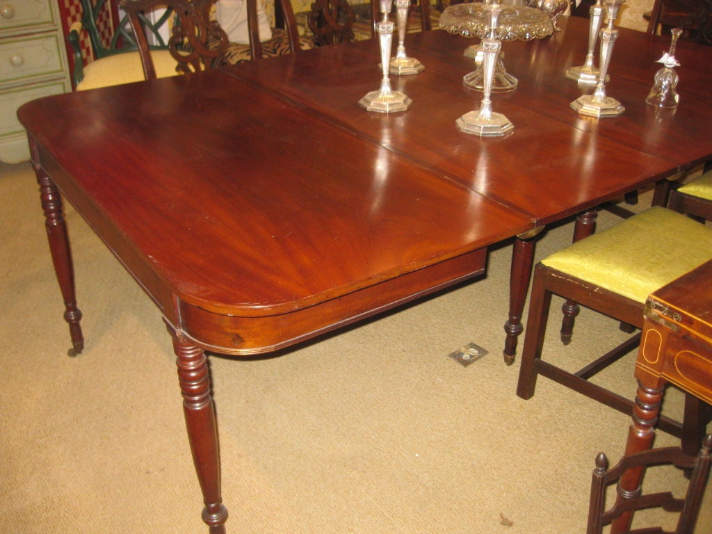 American Federal Period Mahogany Circa 1800 Dining Table   There are  two end tables with four legs.  The back legs swing back to hold two leaves.  The mahogany top has a beautiful flame grain.