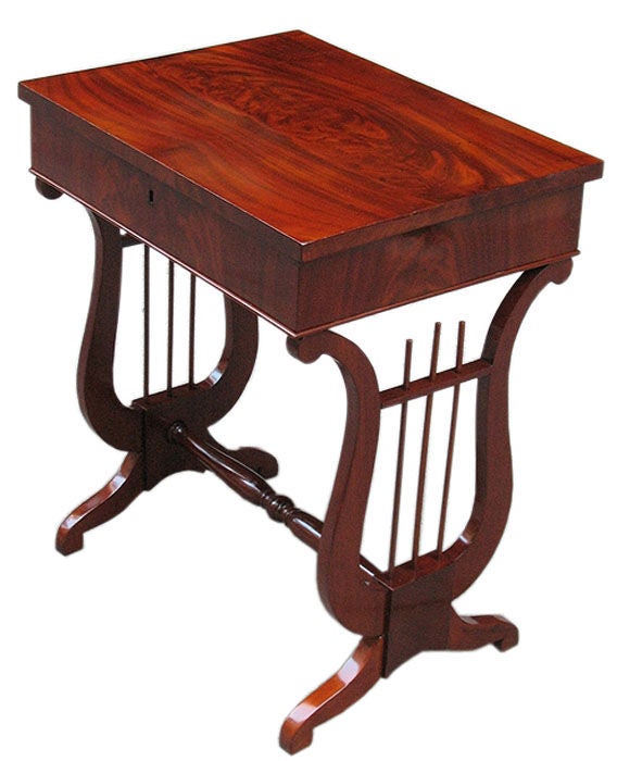 Superb quality Viennese Biedermeier tilt-top side table in which the lyre (one of the main motifs in Biedermeier) is the focus of the design. Mahogany matching veneered on oak. Fitted interior in cherry wood. Original brass lock. 

References are