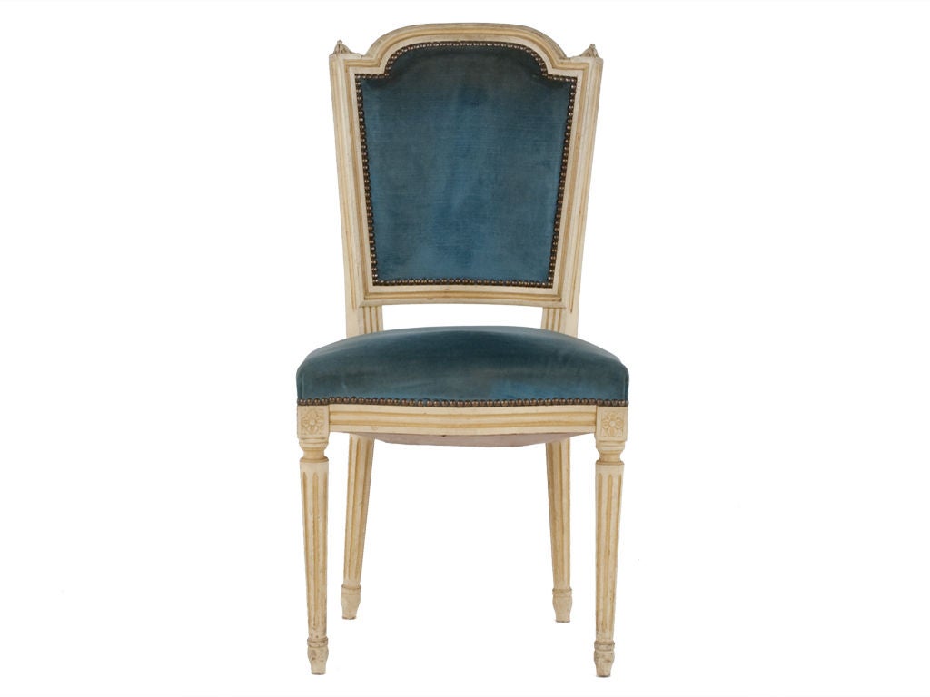 Charming cream framed chair with brass nail head trim and original velvet upholstery. Beautiful detailing in the frame. Set of four available(priced individually).