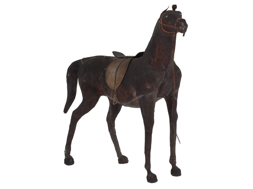 Vintage wooden horse cloaked in leather. Beautiful harness leather and metal details.