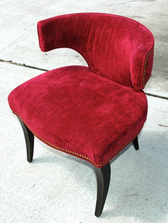 Featured are a pair of Art Deco style game chairs.hey came from Swain a well know manufacturer; fabric by Manuel Canovas<br />
Covered in a burgundy velvet like material with brass tacks. The legs are black with thin gold stripe. These chairs were
