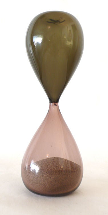 Created in Italy, circa 1955, the Paolo Venini Designed Hourglass sand timer is a timeless work of art. This particular example is in excellent shape and retains the acid etched venini murano insignia to the underside.