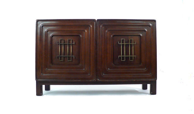 Exquisitely crafted Edmond Spence credenza. Two hand-carved doors conceal to removable felt lined storage trays and three segmented storage spaces. A very rare piece and a masterful blend of Asian and Aztec design. Signed on the back with the Edmond