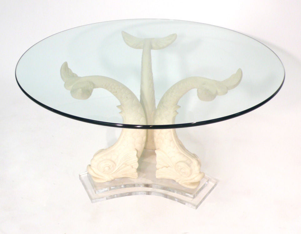 This glamorous table is comprised of three stylized cast plaster dolphins mounted to a stacked Lucite base.