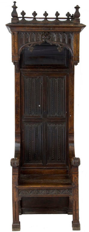 An impressive 16th Century and later French Gothic walnut Bishops throne, Incorporating very fine carved linen fold panels to the back and carved castellated canopy. Circa 1500 and later