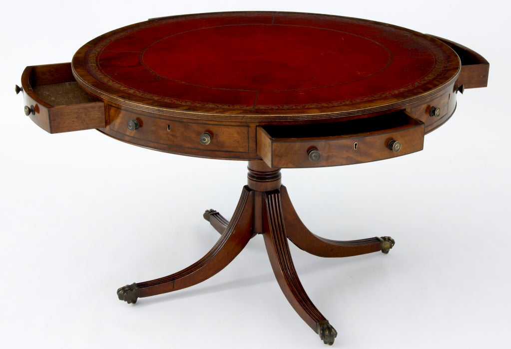 A very good quality late 19th century revolving top drum table with tooled leather top over drawers on turned mahogany pedestal with four reeded mahogany splay legs on brass castors circa 1880