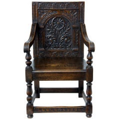 A 17th century style carved oak wainscot armchair 19th century