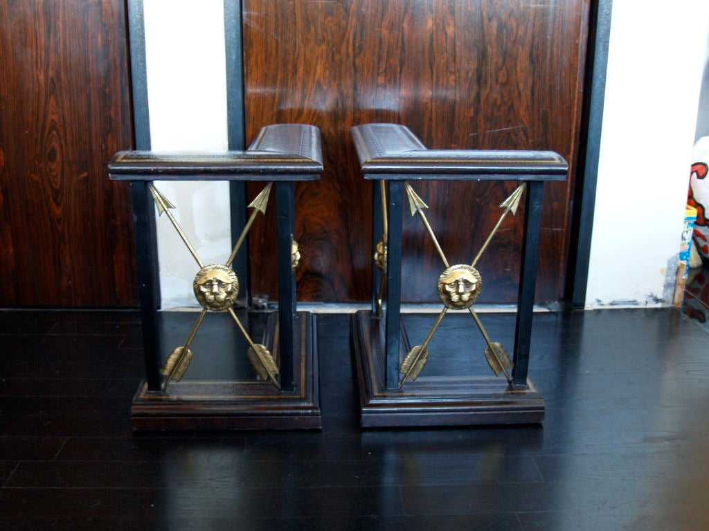 a great fireplace dressing presented before you. they are made of wood wrapped in leather with brass arrows and lion head medallions. i have never seen these before and therefore do not know of the maker or designer. they are in wonderful condition