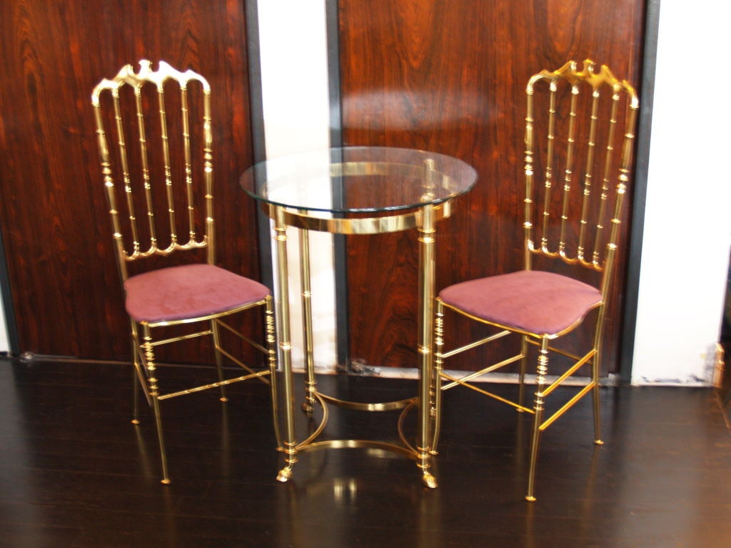 a great little set consisting of a pair of brass Chiavari chairs and a matching table. they are in perfect condition. use as a set, break it up? it your call. also have another exact table in a lower table height.