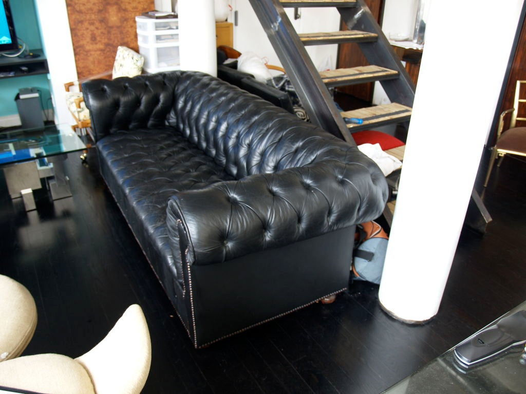 a sleek and sexy black leather chesterfield sofa in fantastic condition. a very masculine sofa that really is timeless and can mix well with modern, traditional, antiques etc. it has a soft supple wear to it. to rips or damage. very good condition