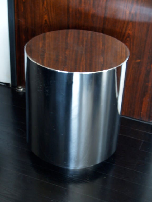 a pair of drum style end tables made of steel in a chrome finish.<br />
 scratches to tops on both tables otherwise in great condition.