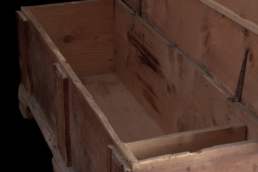 Primitive low chest with single slabs of wood, simple construction.