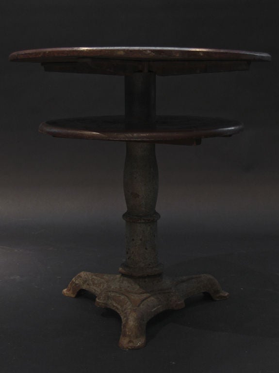 Unusual two tier wood table with cast iron base, used as a prohibition table to hide<br />
on the second shelf any alcohol.