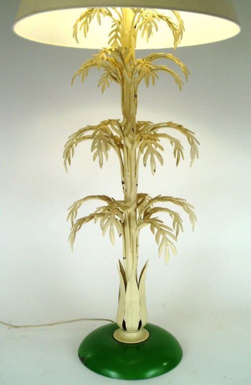 an unusual and charming tall painted steel palm lamp. beautiful form, with 4 tiers of leaves, and a round base. double sockets.