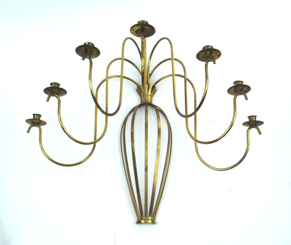 A beautiful and elegant large brass sconce, with a domed, banded base gathered at the top, and 7 graceful sweeping arms supporting brass candle mounts. Perfect aged patina.