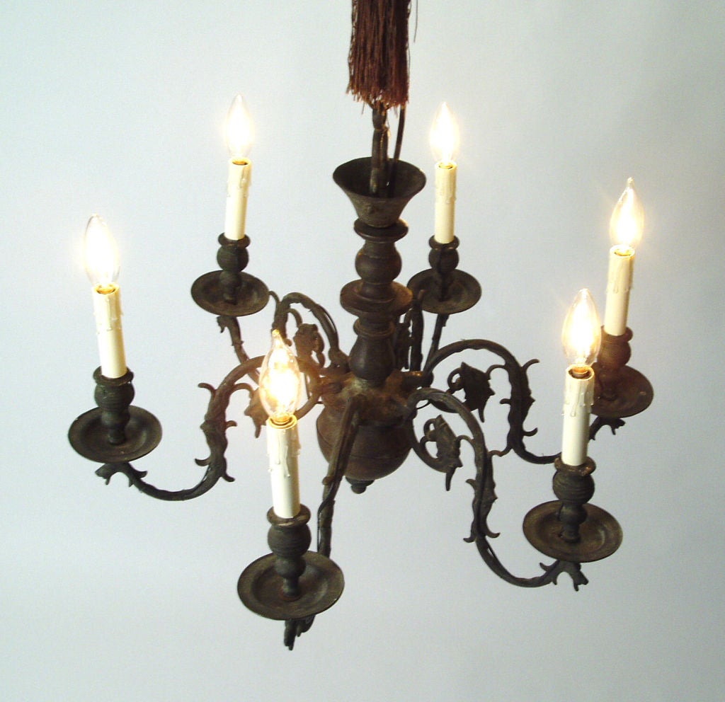 a bronze Dutch chandelier with exquisite details. Six arms each with Griffon Head facing the light. was originally candle-lit, but has been wired. very heavy and well cast details and very nice patina.
