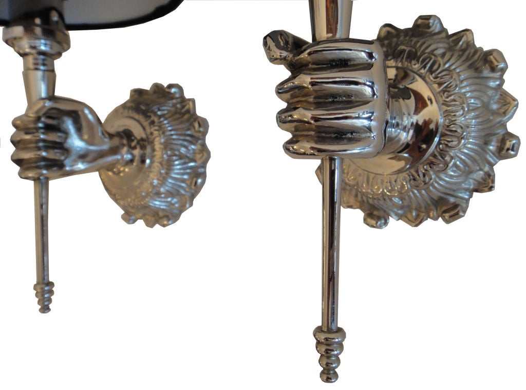 Three pairs available of nickel-plated French sconces featuring a hand holding a torch. Back plate diameter: 3. 3/4