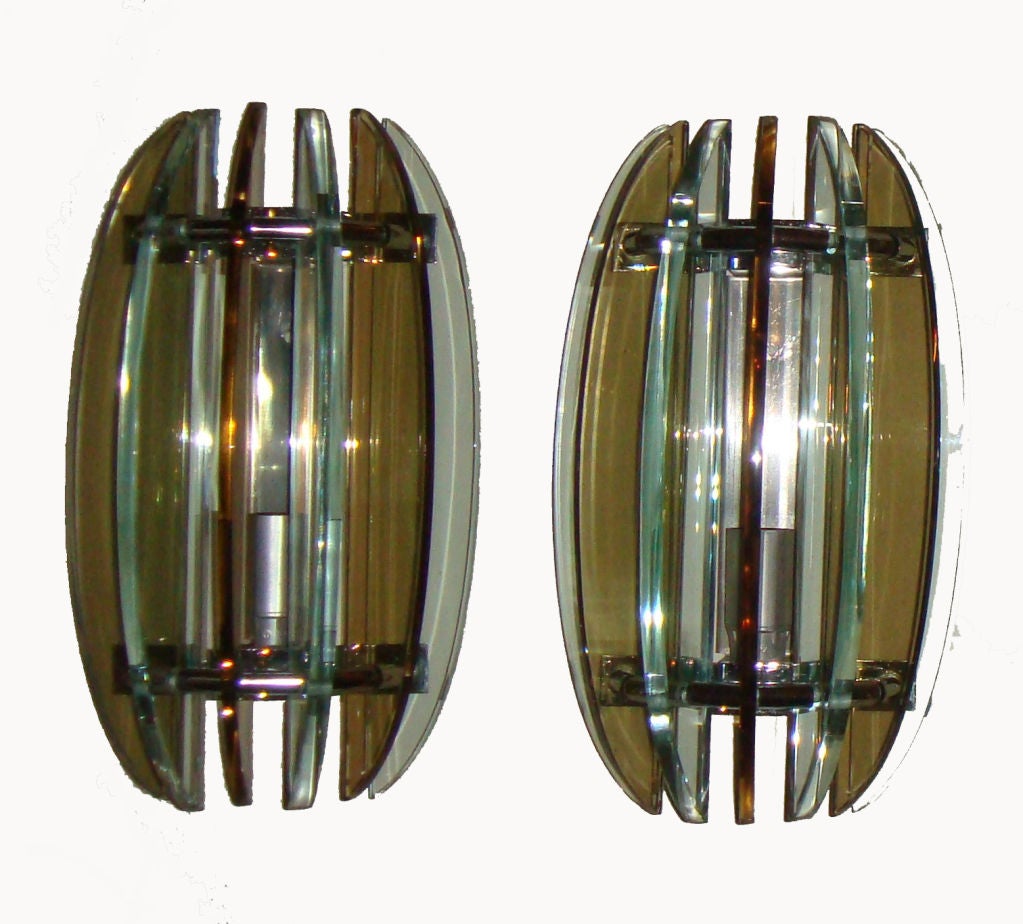 Italian sconces with seven alternating clear and smoked pieces of beveled glass on a polished chrome frame.
US wired and in working condition. Takes 1 Light bulb max. 60 watts or LED bulb.
Have a look on our impressive collection of French and