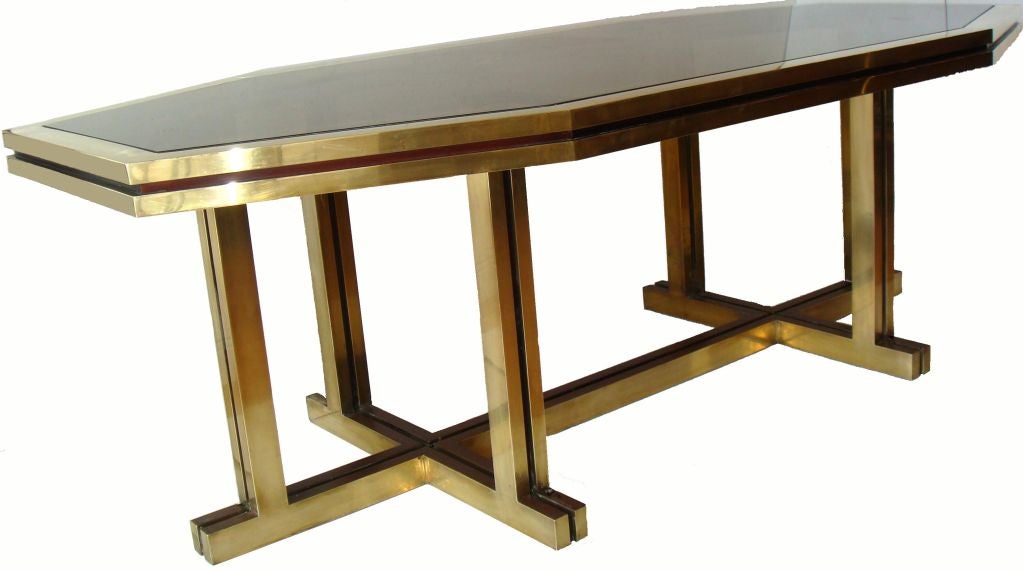 Impressive octagonal brass dining table by Maison Jansen. Floating top with smoked Glass. 
Can be also used as a desk. 
Seats easily 12 people comfortable.